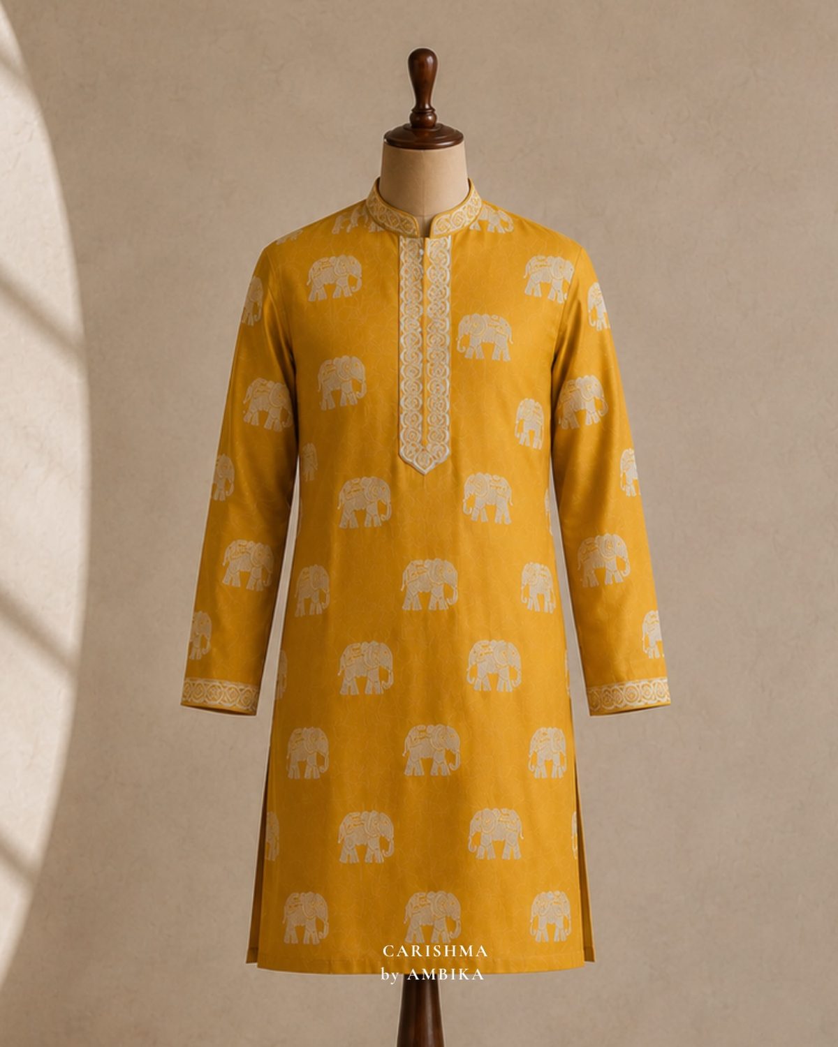 Mustard kurta with elephant motifs on a mannequin